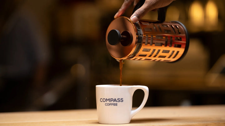 A happy group of people share stories over a French Press of real good coffee in Washington, DC.