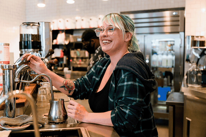 Smiling barista serves best coffee in DC