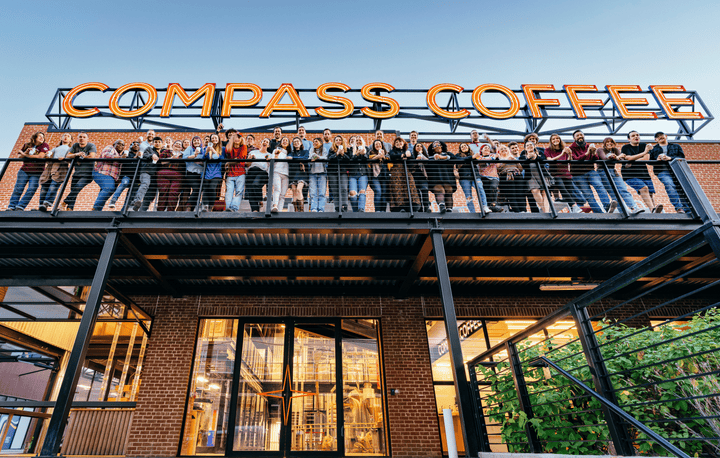 Compass Coffee team standing on the balcony in ivy city 